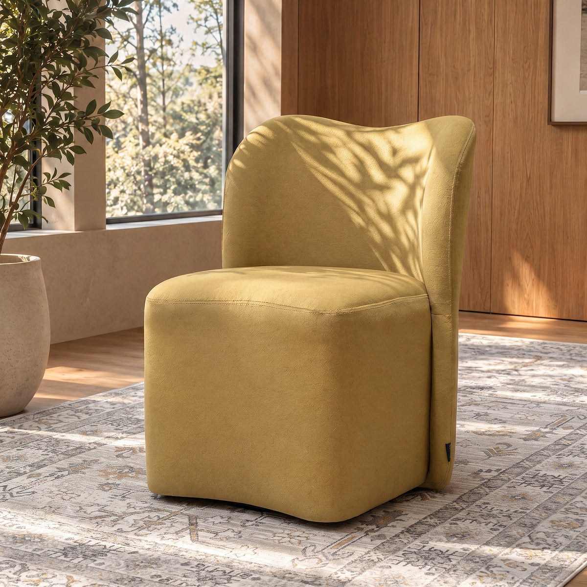 Mustard yellow upholstered chair in a stylish sunlit room with rug and plant