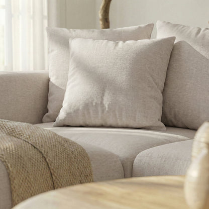 Close-up of corner seat cushions of a beige sectional sofa in a lifestyle setting