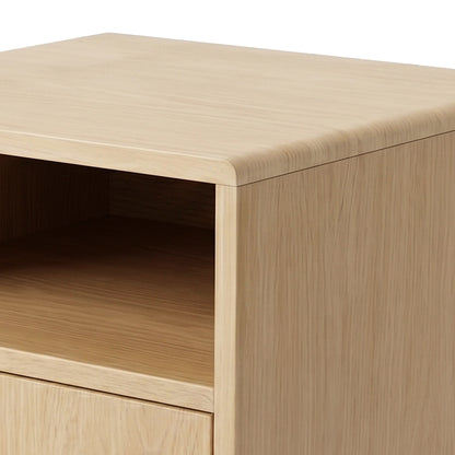 Partial view of the top and front of a wooden nightstand on white background
