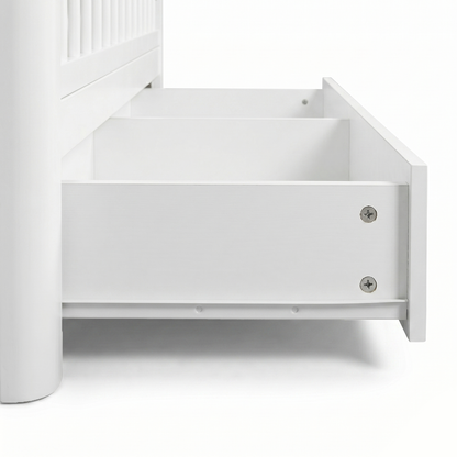 Close-up of crib drawer hardware and base