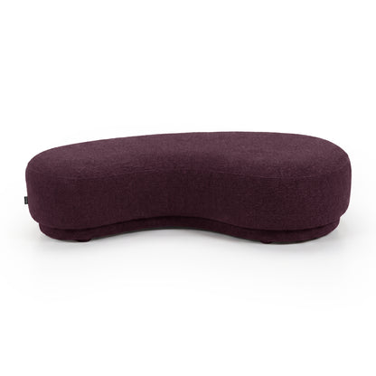 Modern bean-shaped plum upholstered bench seat on a white background