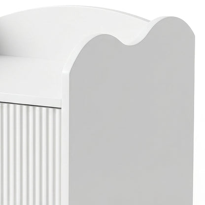 Partial view of white furniture with ribbed side panel and curved top edge on white background