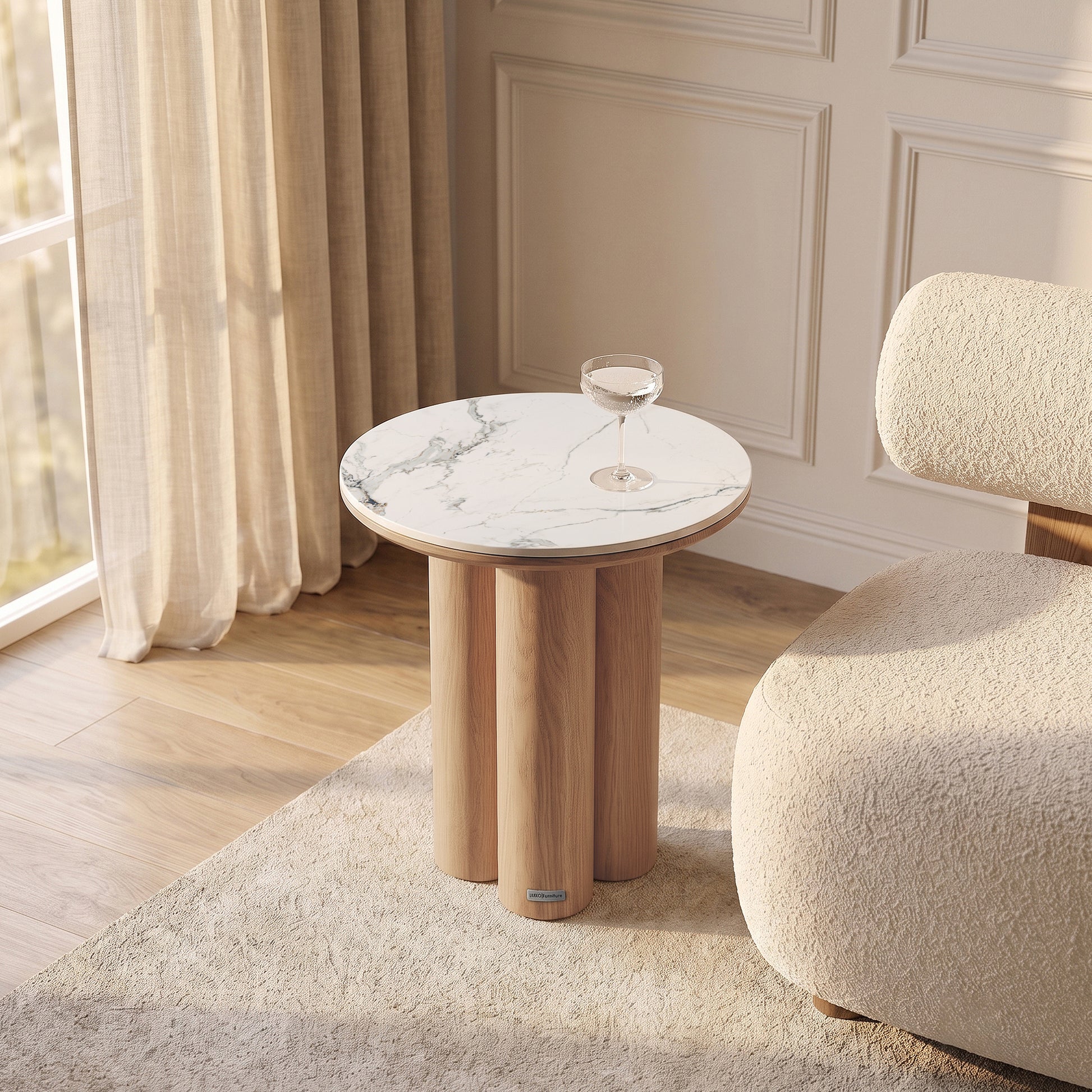 Modern round side table styled in a bright room with chair and curtains