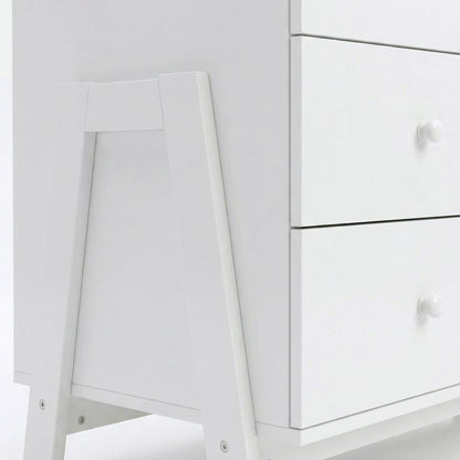 Close-up of bottom corner and drawer fronts of white dresser