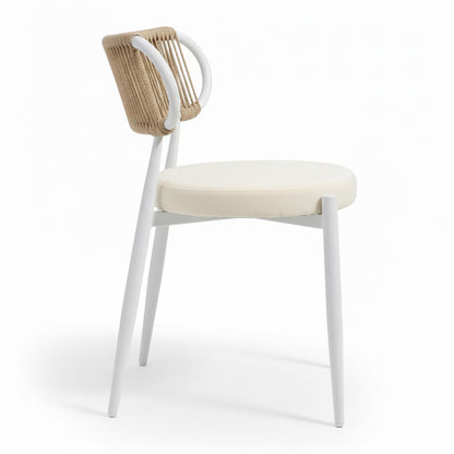 Cabria 7 Piece Sintered Stone Outdoor Dining Set features a modern side-chair with a slim white frame, cream-beige cushion, and backrest wrapped in natural-tone cord, enhancing its minimalist aesthetic.