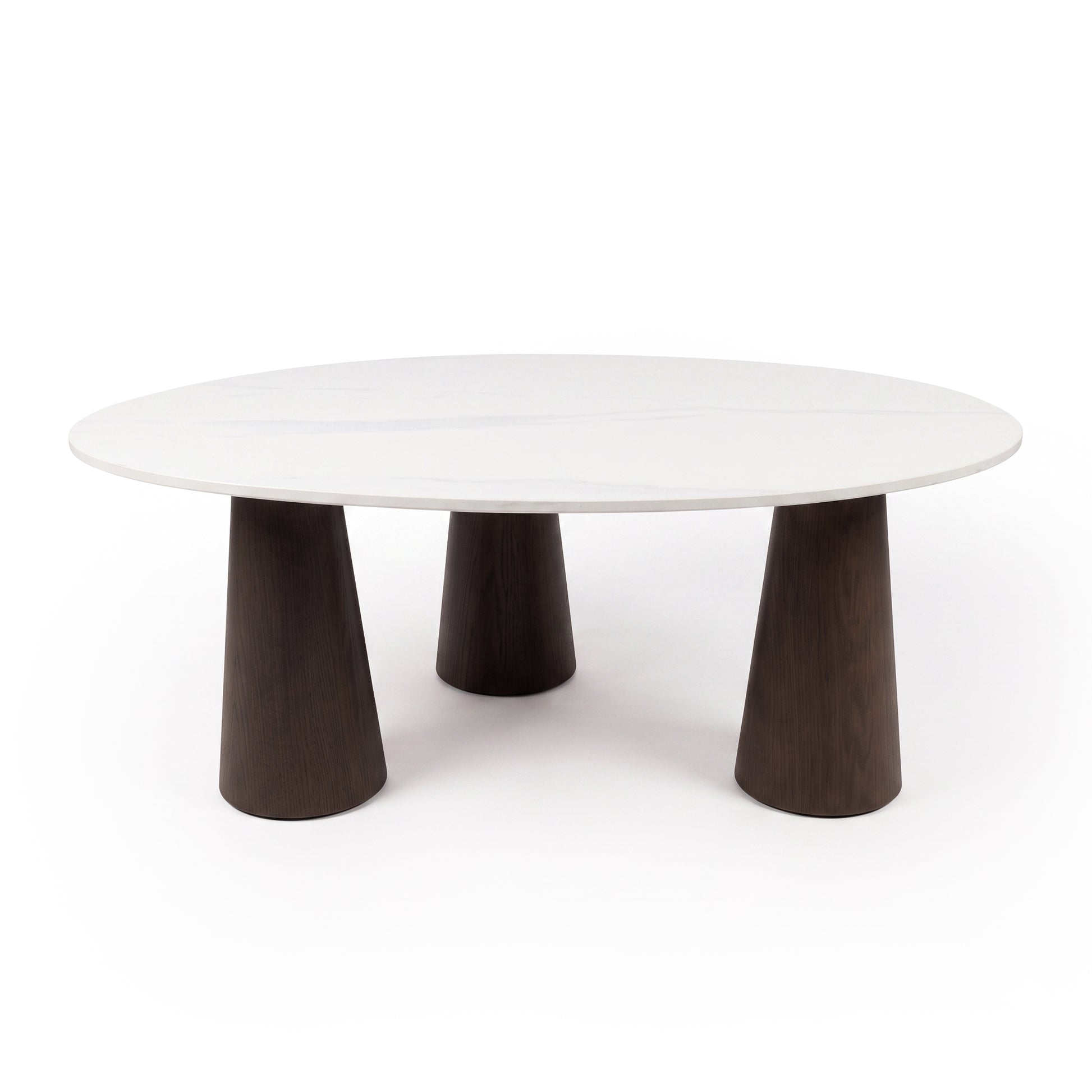 Modern round coffee table with white top and three dark wood legs on a white background