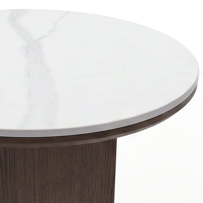 Close-up of the edge and top surface of a round table with a white marble-like finish and wood base on a white background