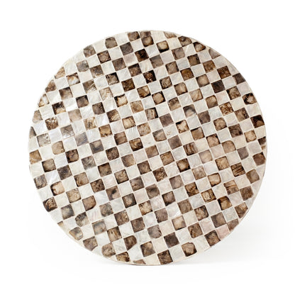 Overhead view of a round checkered tabletop on white background