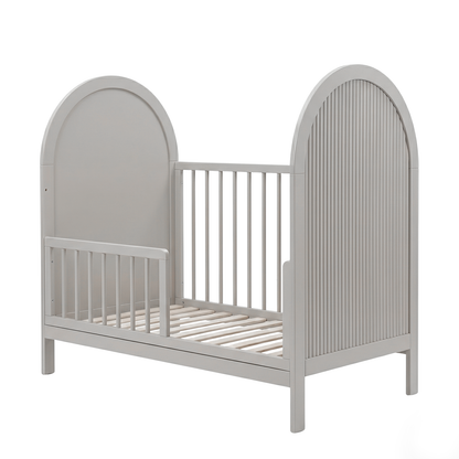 Gray toddler bed with open side on white background