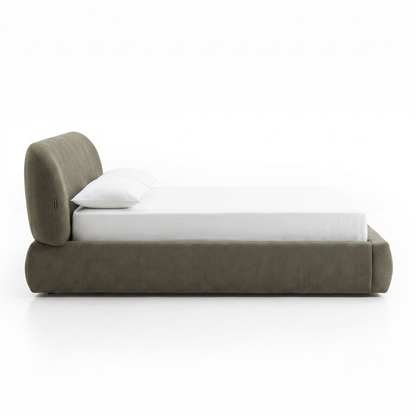 Side view of an upholstered bed on a white background