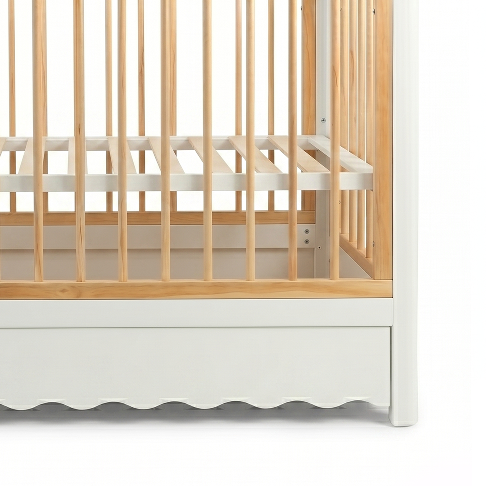 Close-up of baby crib corner detail on white background