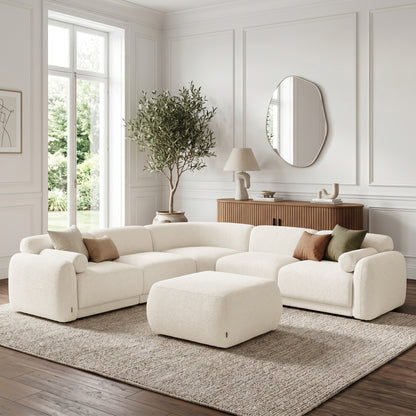 Modular sectional sofa with ottoman in a bright styled living room