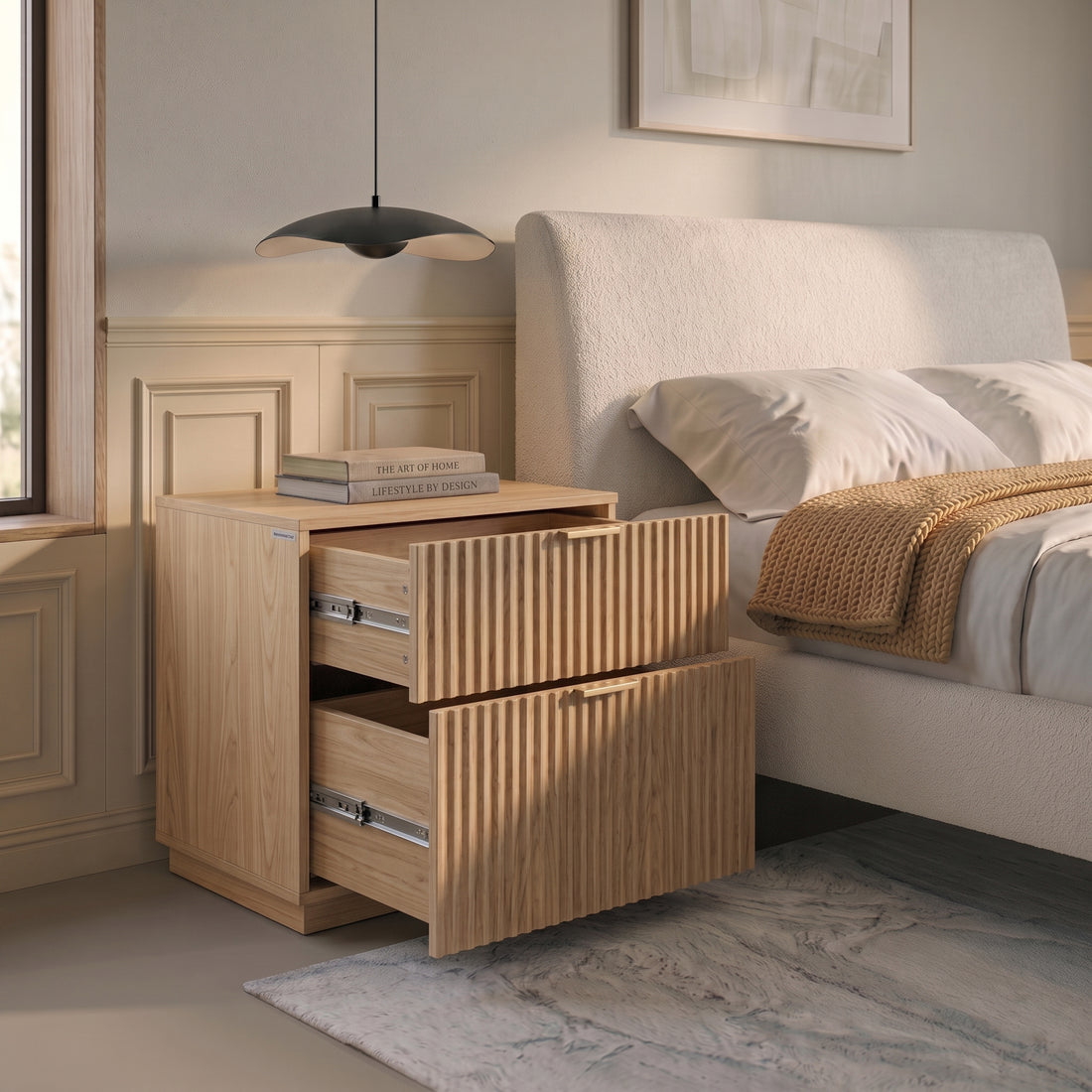Wooden nightstand with open drawers beside a bed in a styled bedroom