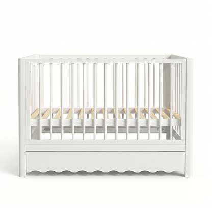White baby crib with vertical slats on white background