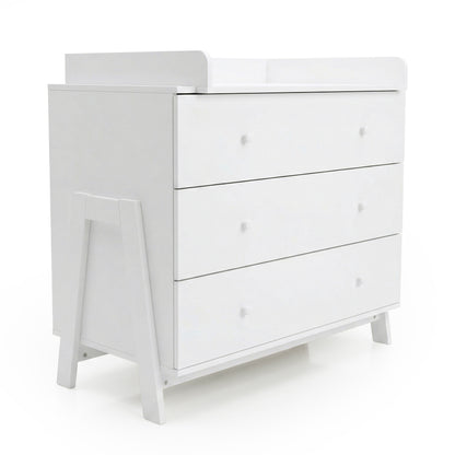 Angled view of white three-drawer dresser with raised changing tray