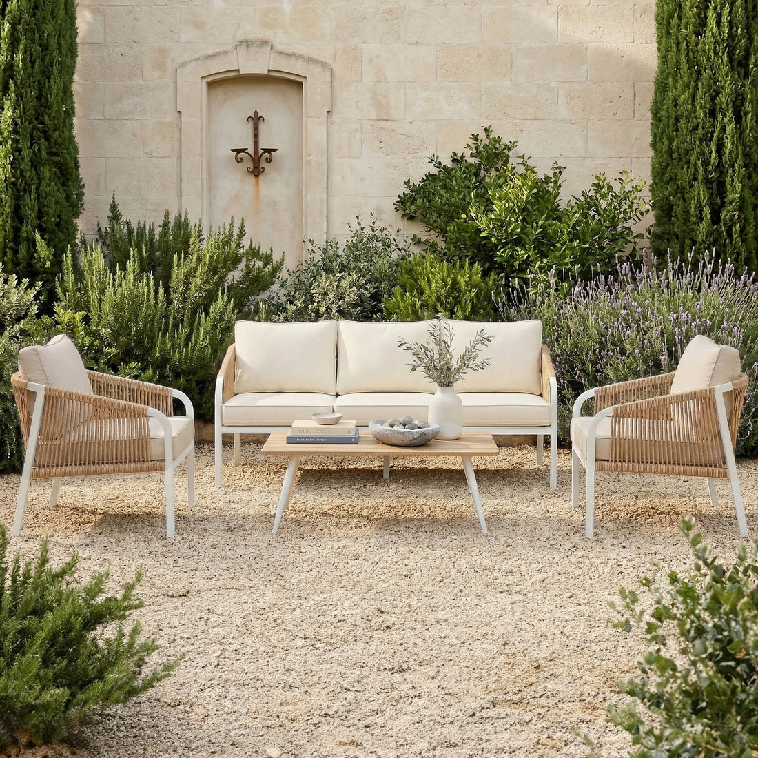 Vernon Outdoor Cushion Covers Set of 5 in Cream White transform the patio's woven-rope armchairs and sofa with sleek, weather-ready covers, enhancing the serene setting against a lush, green Mediterranean backdrop.