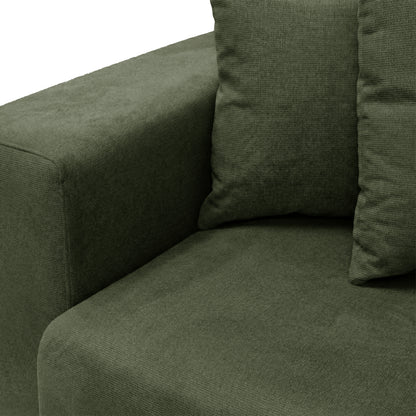 Corner view of dark green sofa with two pillows on white background