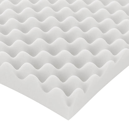 Close-up of white egg-crate foam pad corner on a white background