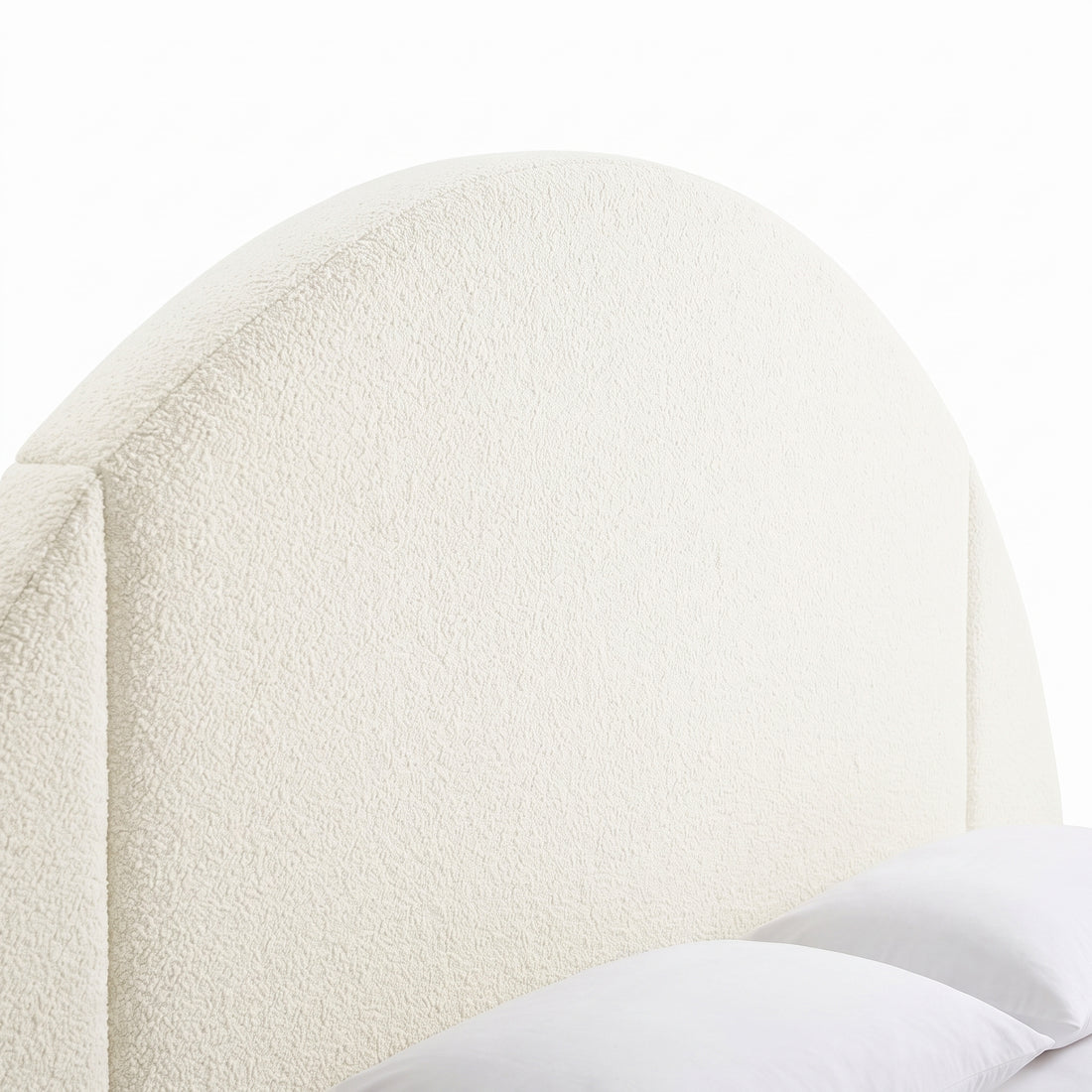 Close-up of an upholstered arched headboard on a white background