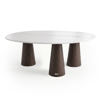 Modern round table with white top and three dark wood legs on a white background