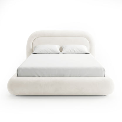 Front view of upholstered bed with pillows on white background