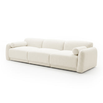 Off-white three-seater sofa with cylindrical bolster pillows on white background