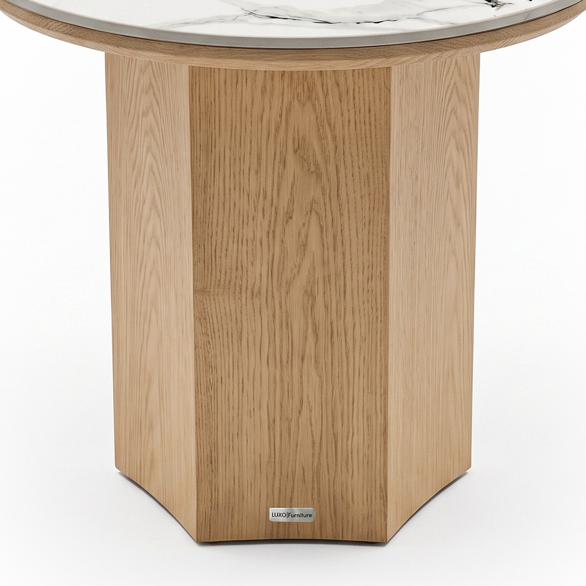 Partial view of a round table with a geometric wood base and marble top on a white background.