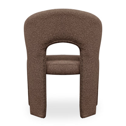 Lunari Bouclé Curved Accent Chair in Brown features a sculptural design with a curved backrest, central cut-out, and U-shaped legs, upholstered in soft bouclé fabric for modern elegance.