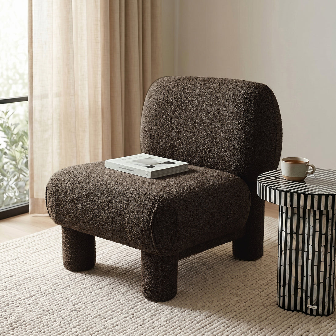 Dark brown accent chair in a cozy living room with side table and open book