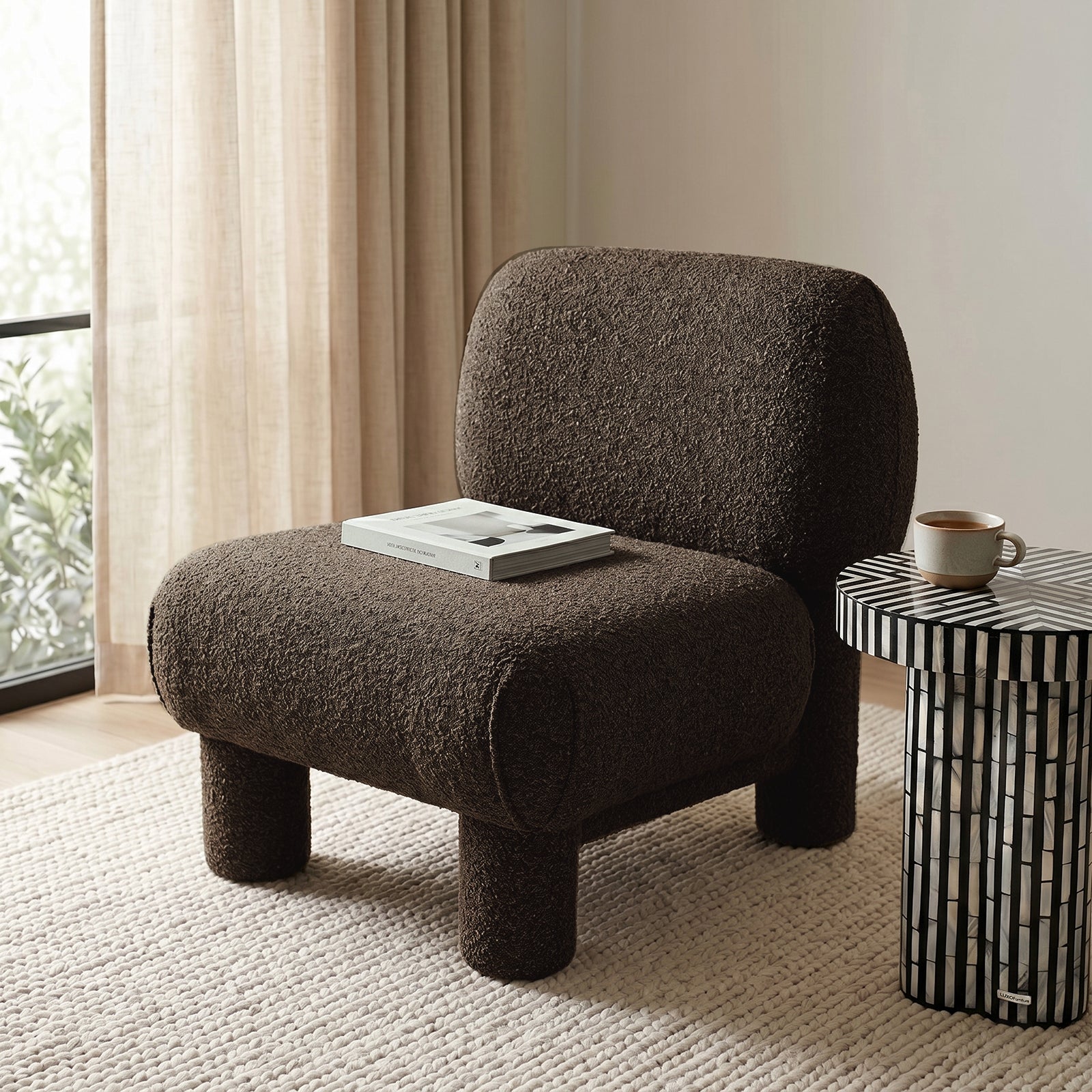 Dark brown accent chair in a cozy living room with side table and open book