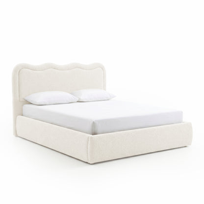 Modern upholstered bed with pillows on white background