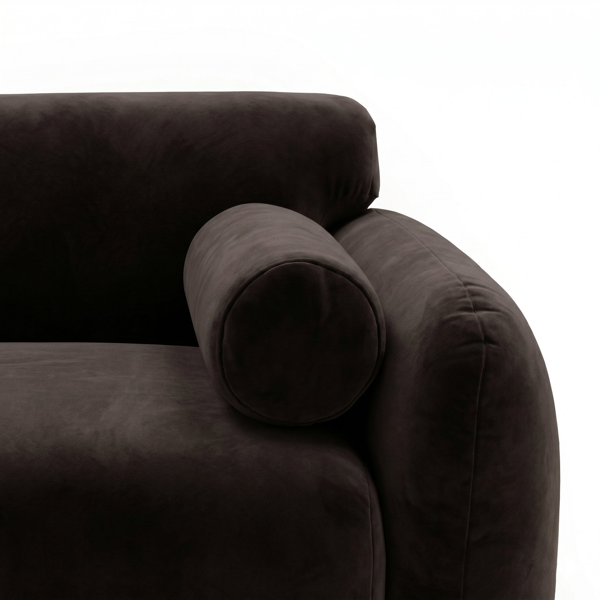 Close-up of dark brown sofa armrest and bolster pillow on white background