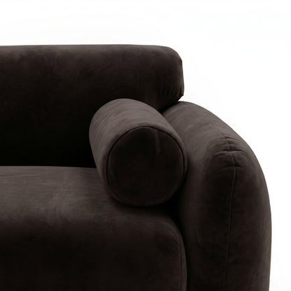 Close-up of dark brown sofa armrest and bolster pillow on white background