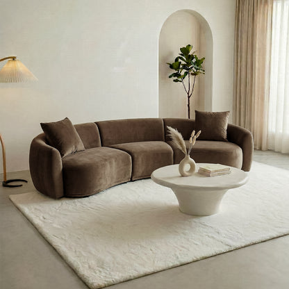 Modern living room with curved brown sofa