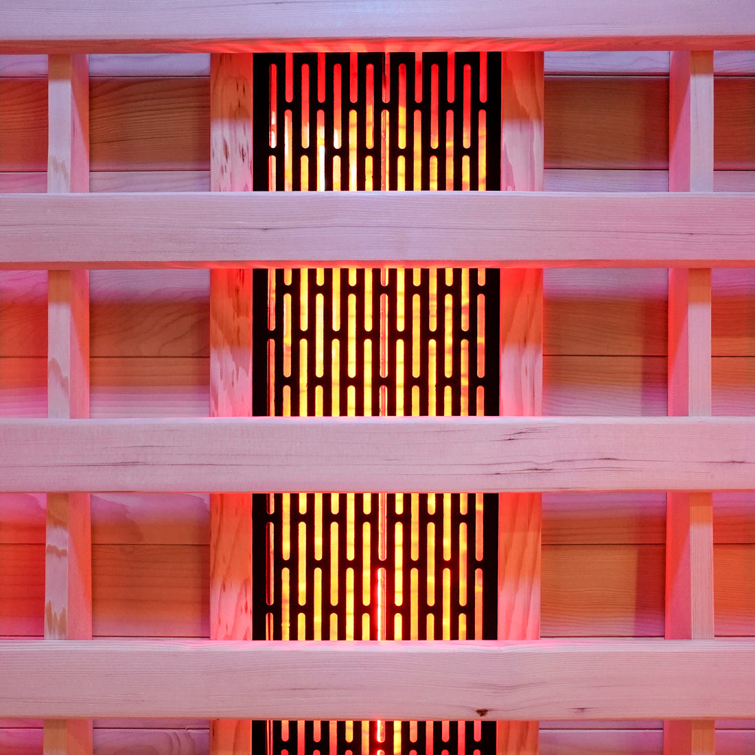 Close-up of wooden slats with glowing sauna heating panel behind them
