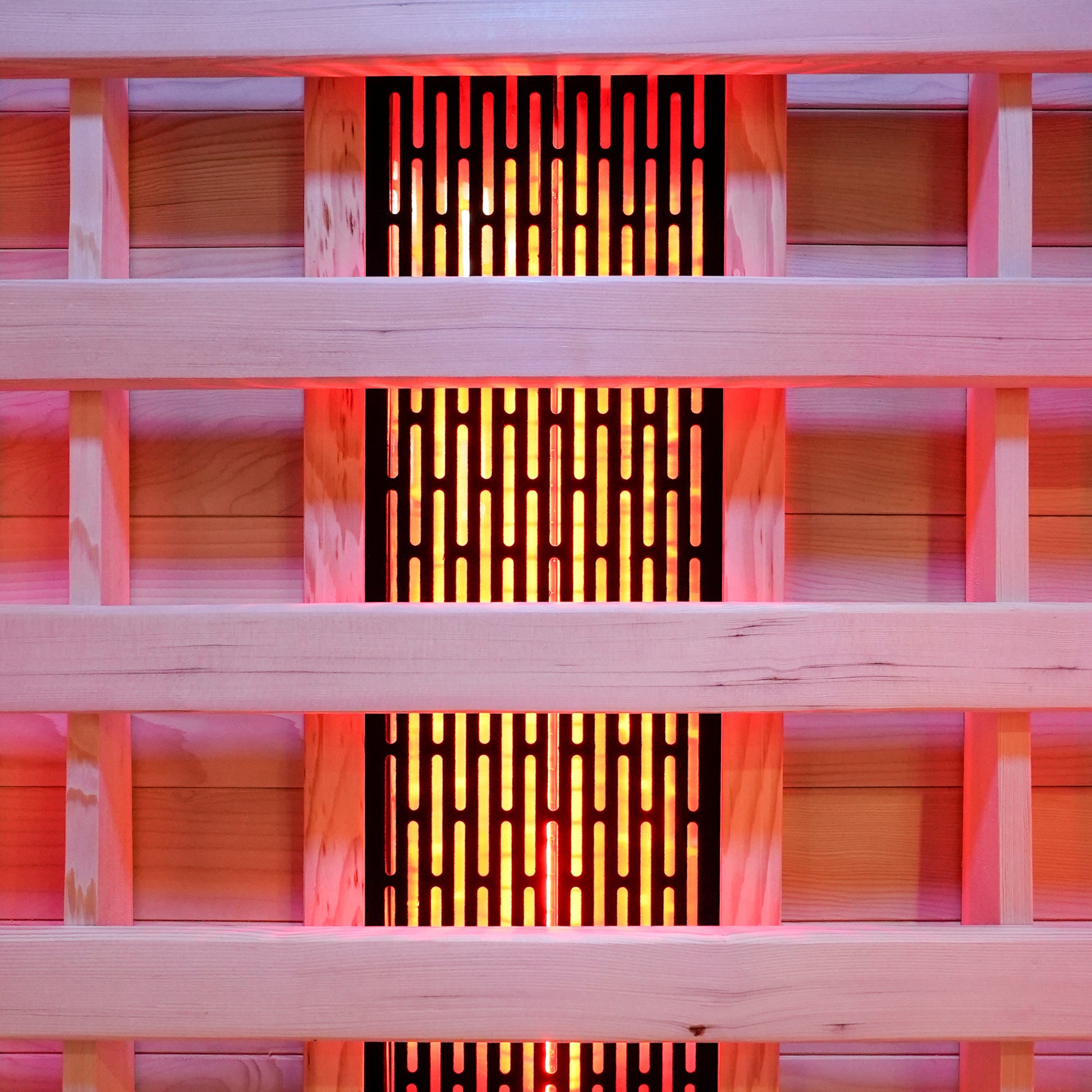 Close-up of wooden slats with glowing sauna heating panel behind them