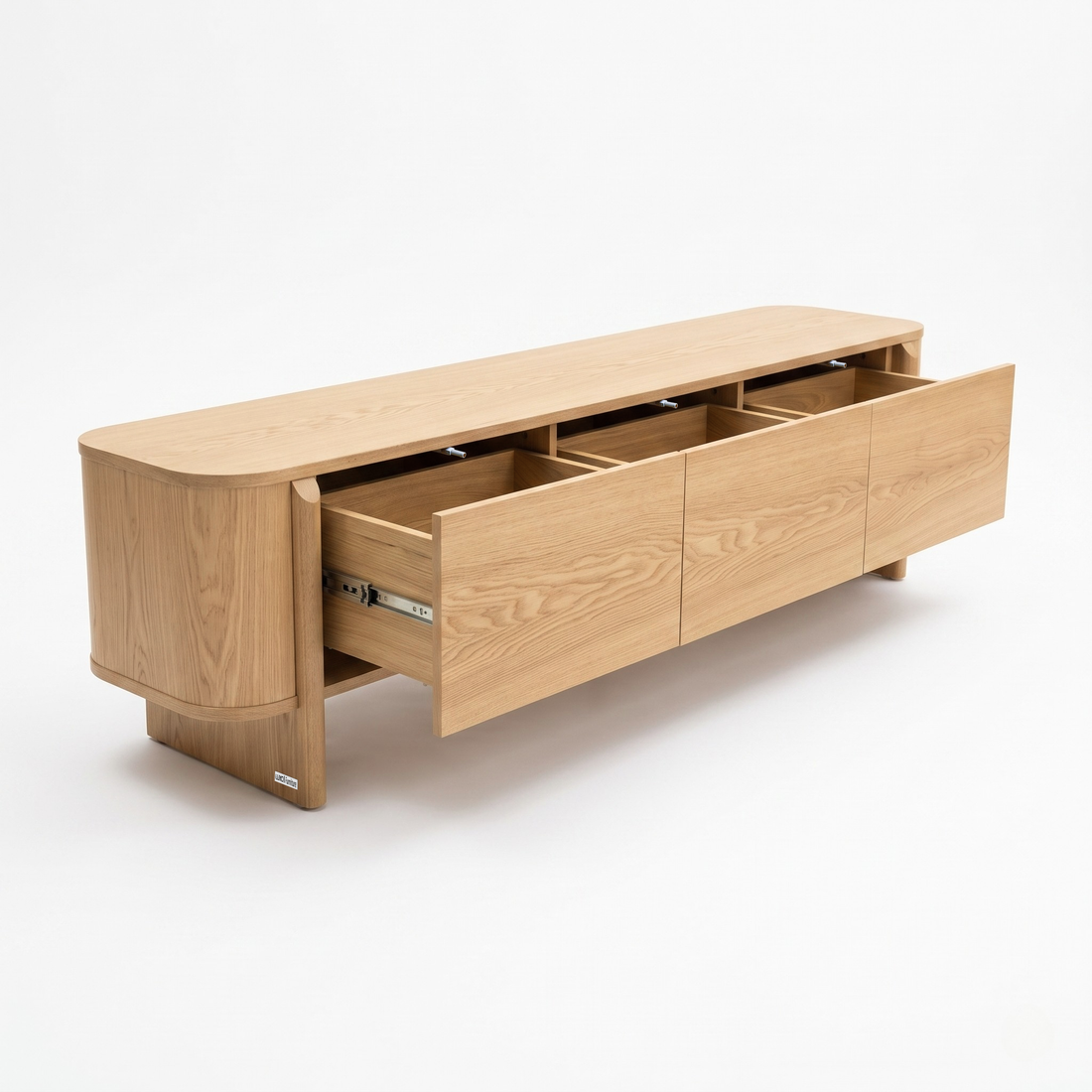 Light wood sideboard on a white background with three drawers partially open