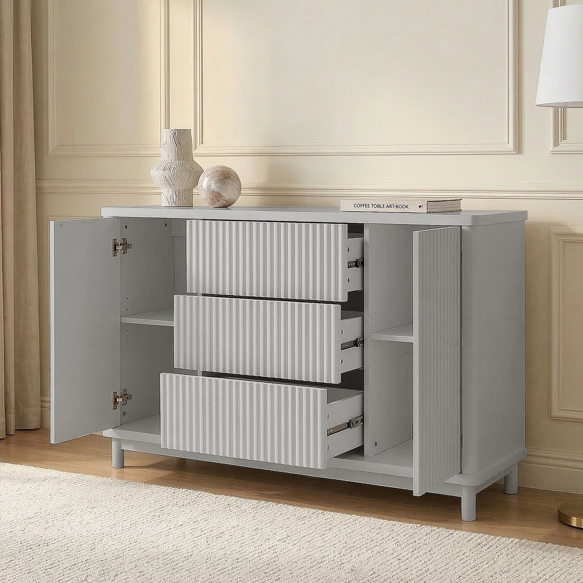 Open light gray cabinet drawers in a styled room