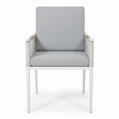 Casara 7 Piece Outdoor Dining Set in White & Grey, featuring a modern armchair with a slim metal frame, rope-wrapped armrests, wooden rail, and boxy light gray cushions. Ideal for stylish outdoor dining.