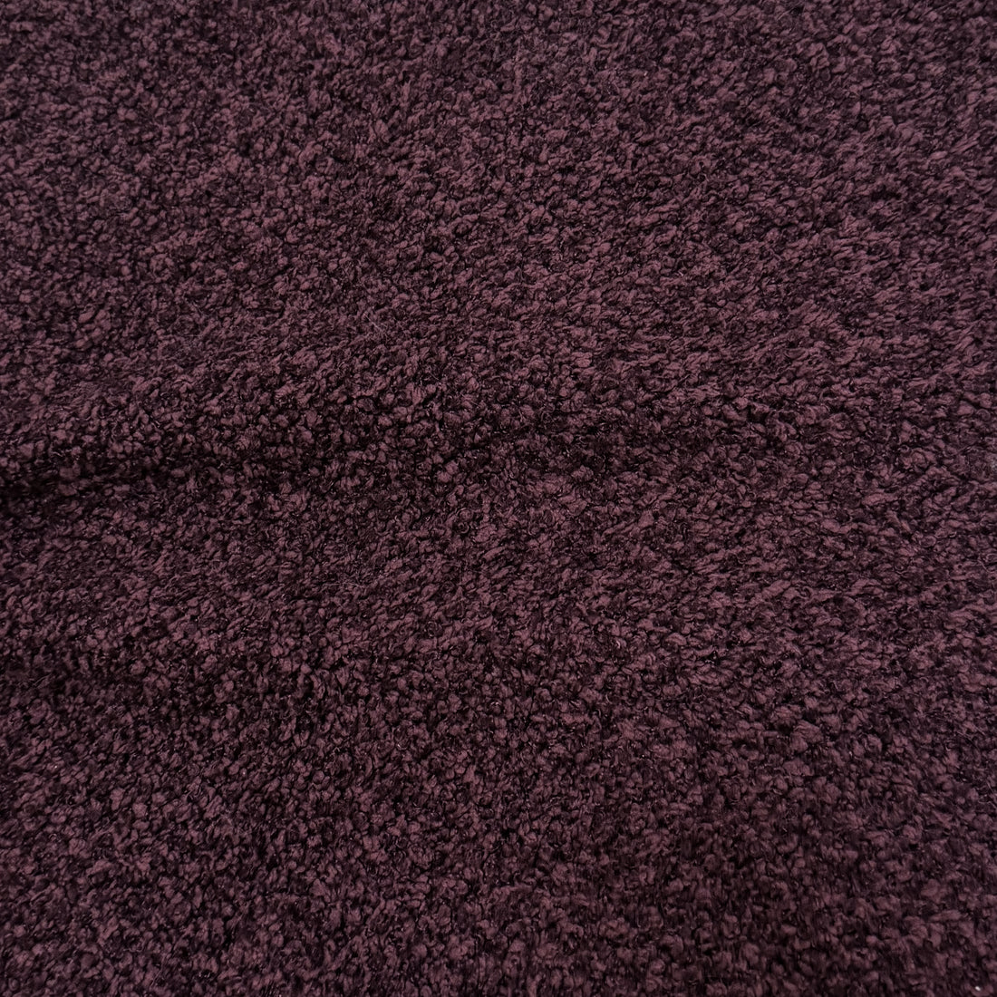 Close-up of plum textured fabric upholstery