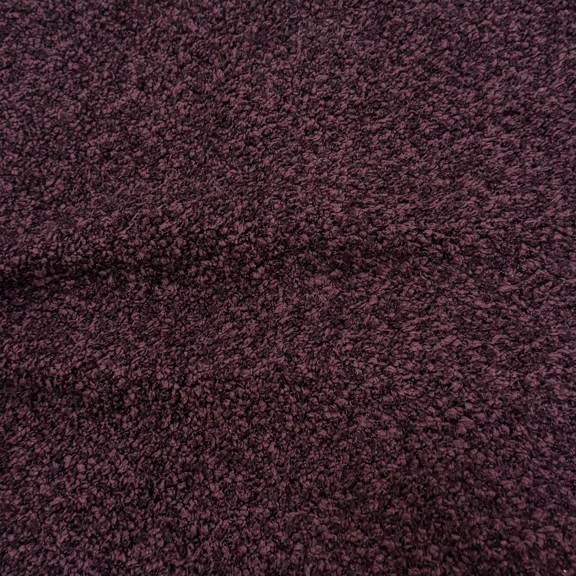 Close-up of plum textured fabric upholstery