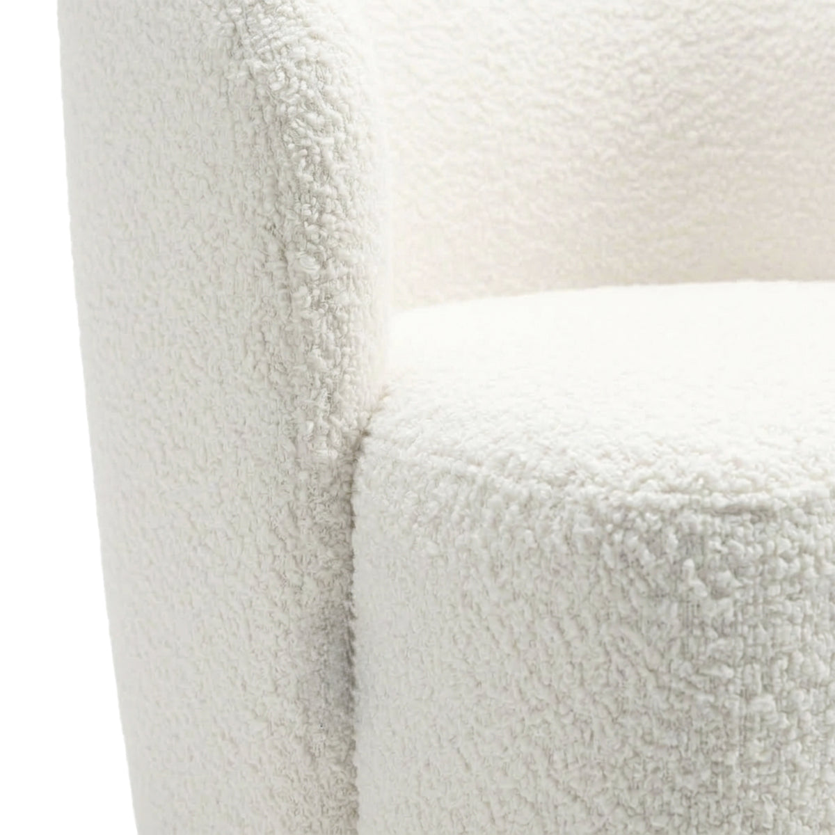 Close-up of white textured upholstered chair fabric and curved arm