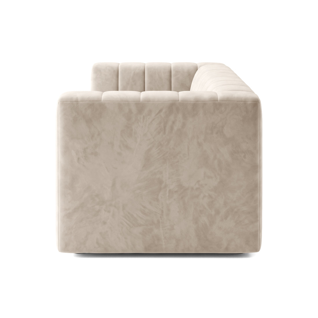 Side profile view of a beige tufted sofa on white background