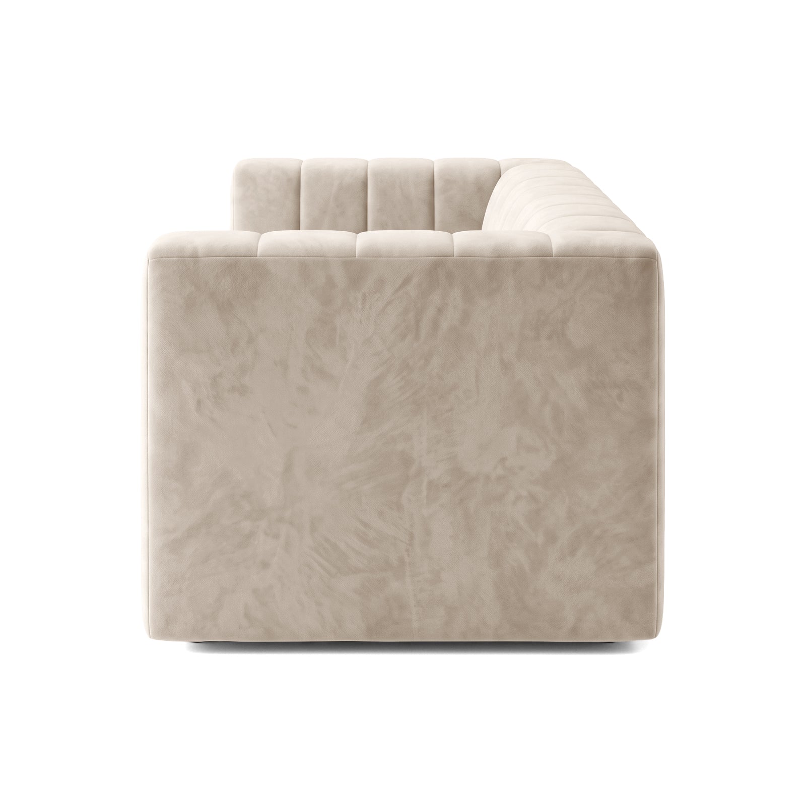 Side profile view of a beige tufted sofa on white background