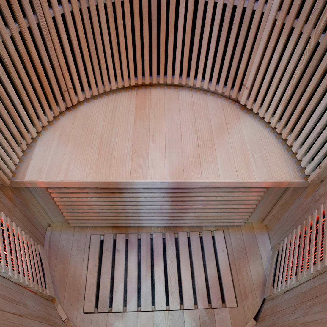 Curved wooden bench inside a sauna