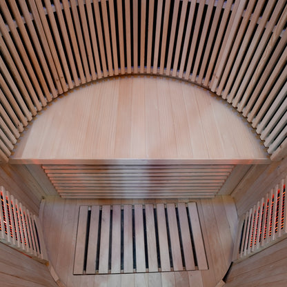 Curved wooden bench inside a sauna