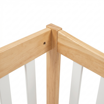 Close-up of a wooden crib corner with white slats