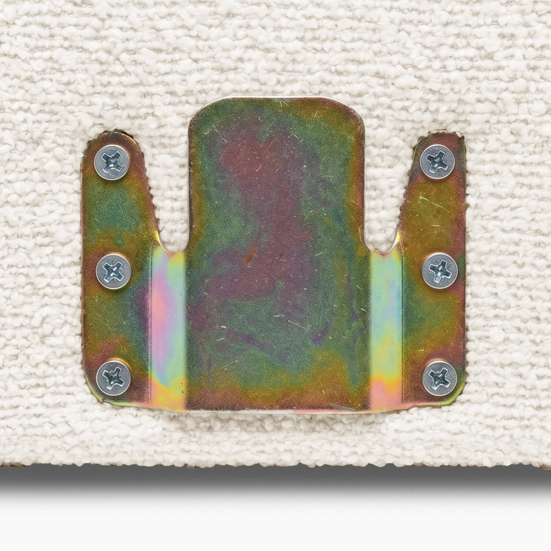 Close-up of metal mounting bracket on upholstery