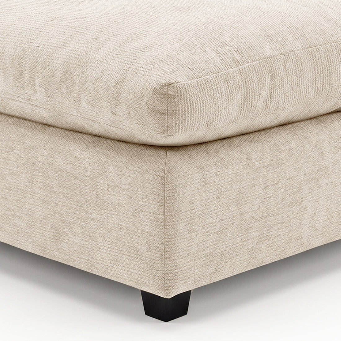 Close-up of beige upholstered furniture corner with visible stitching