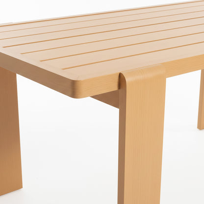 Close-up of the Positano 6 Seater Aluminium Outdoor Dining Set in White, showcasing a light-wood table with shallow grooves and rounded corners, featuring broad legs that wrap over the tabletop edge.
